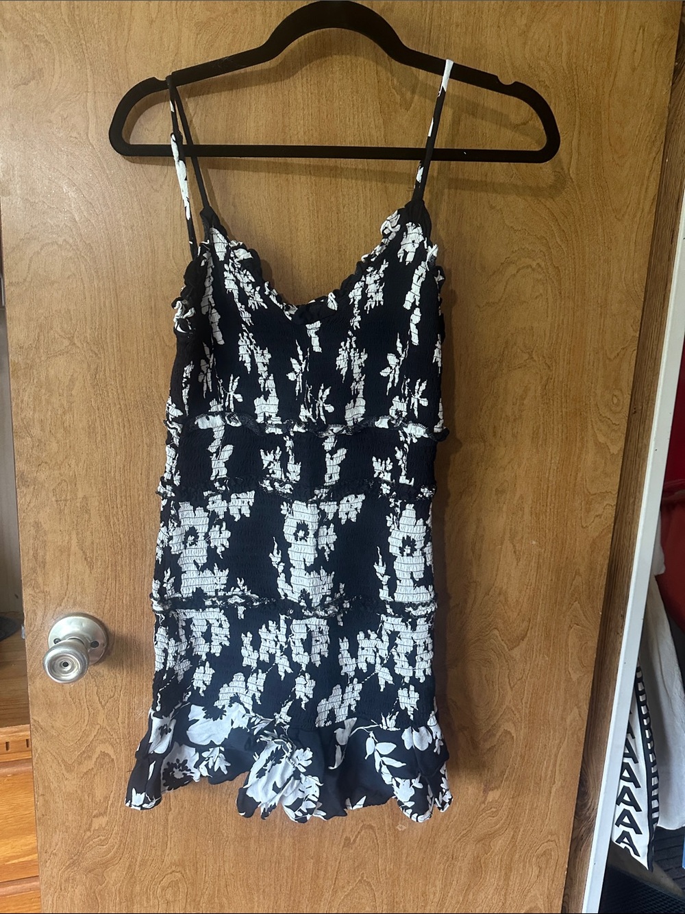 Etiquette Clothiers Black and White Floral Smocked Mini Dress